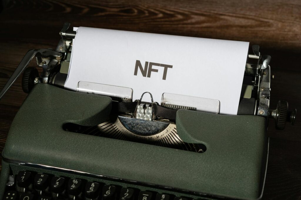 Close-up of a vintage typewriter with the word 'NFT' typed on paper, symbolizing digital innovation.