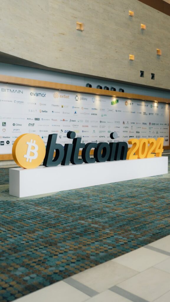 A bitcoin sign in front of a large building