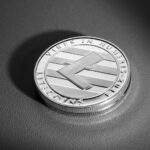 Dramatic close-up of a Litecoin coin on a textured surface, showcasing its design details.