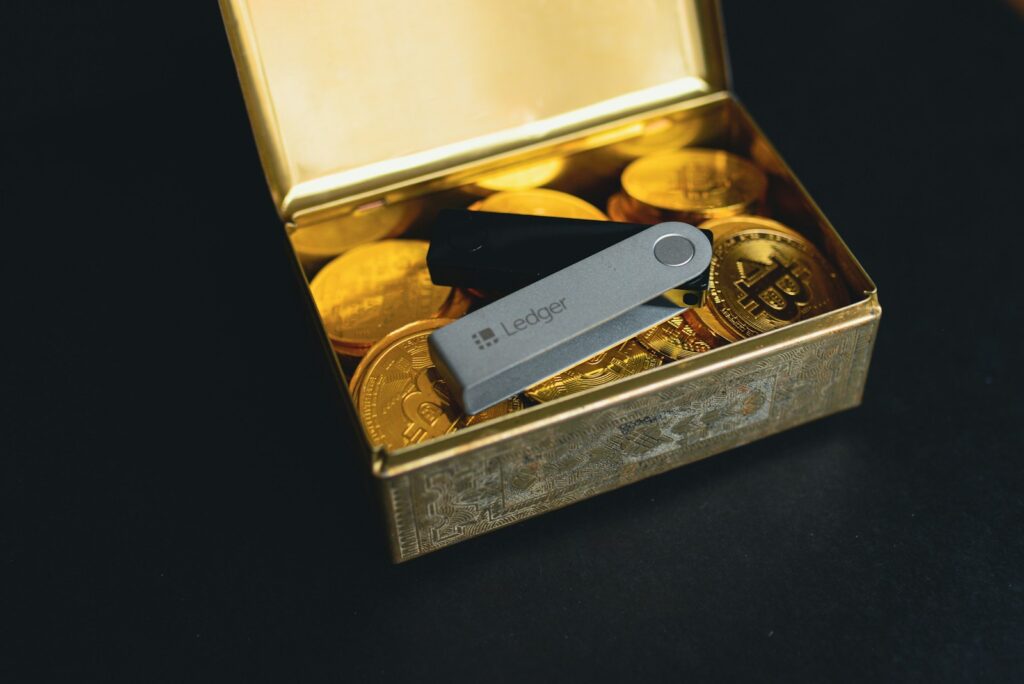 a swiss army knife sitting in a box of gold coins