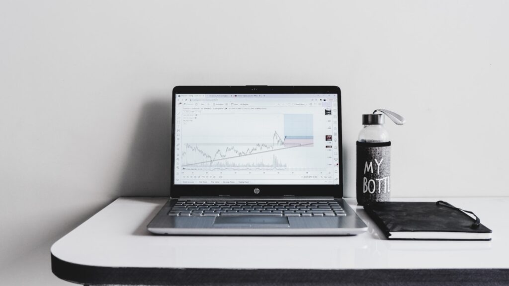 a laptop computer sitting on top of a white desk