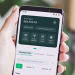 a person holding up a smart phone with an app on the screen